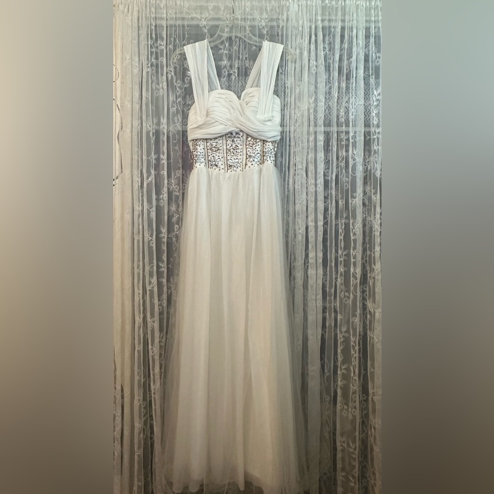 White tulle evening gown with silver and gold rhinestones.